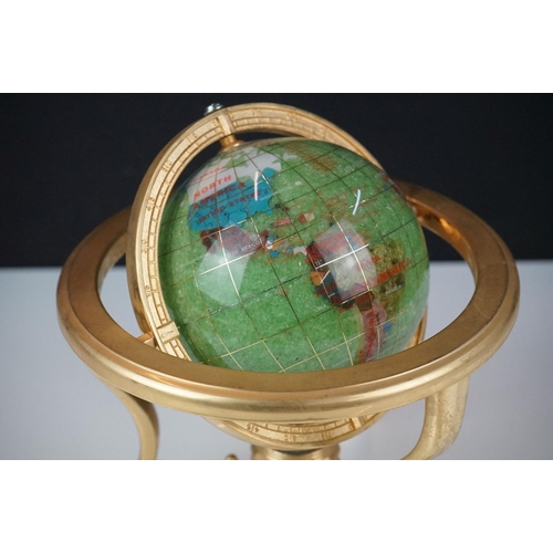 147 - Table top globe made from semi precious stone with compass set to base, raised on three gilt metal l... 