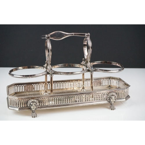 148 - Elkington & Co silver plated tantalus raised on four claw feet with lion mask embellishments, with t... 