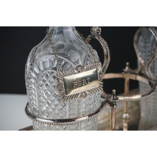 148 - Elkington & Co silver plated tantalus raised on four claw feet with lion mask embellishments, with t... 