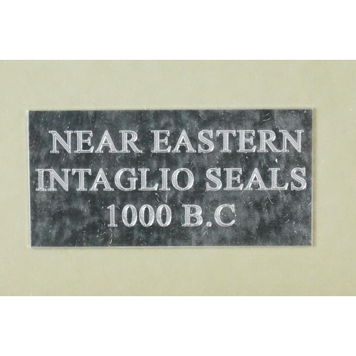 119 - Framed collection of 10 Near Eastern Intaglio Seals, circa 1000 B.C, the intaglios depicting various... 