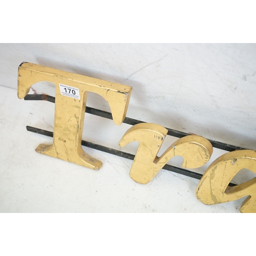 170 - ' Traders ' wooden wall sign mounted on cast iron wall brackets, approx 120cm long