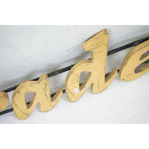 170 - ' Traders ' wooden wall sign mounted on cast iron wall brackets, approx 120cm long