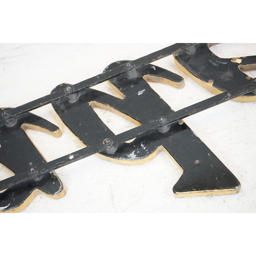 170 - ' Traders ' wooden wall sign mounted on cast iron wall brackets, approx 120cm long