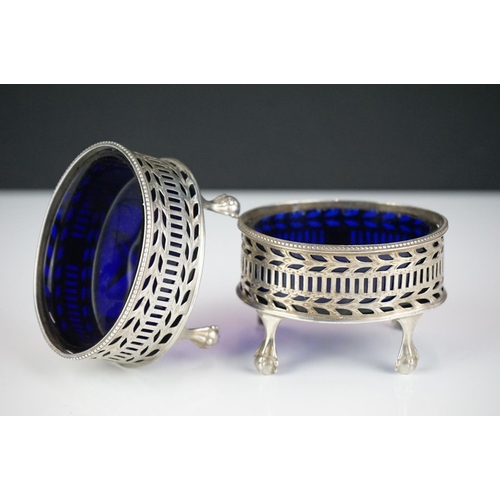 282 - A pair of fully hallmarked sterling silver mustard pots complete with original blue cut glass liners... 