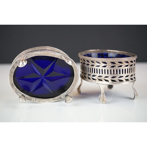 282 - A pair of fully hallmarked sterling silver mustard pots complete with original blue cut glass liners... 