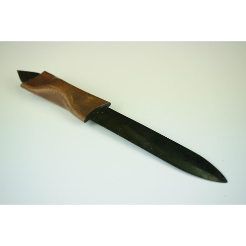 286 - A blackened metal paper knife with formed leather handle.