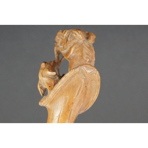 287 - A hand carved wooden umbrella handle in the form of dogs and horses.