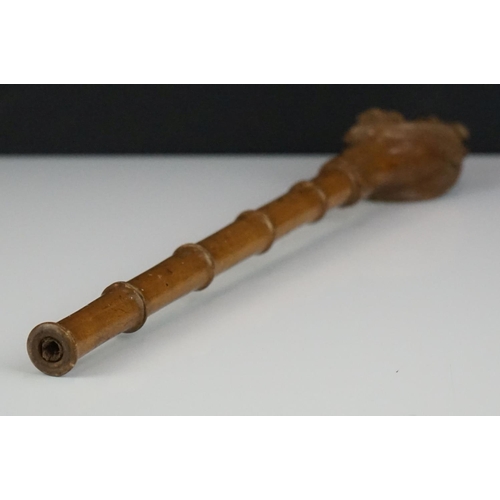 287 - A hand carved wooden umbrella handle in the form of dogs and horses.