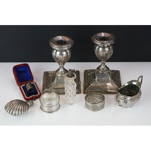 311 - A small collection of hallmarked sterling silver collectables to include candlesticks, napkin ring, ... 