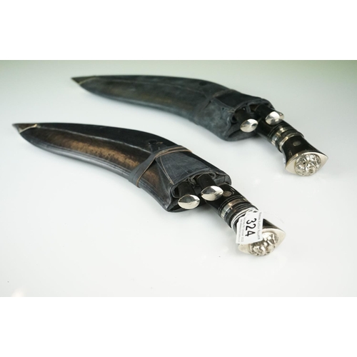 324 - Two kukri knives complete with tools and scabbards.