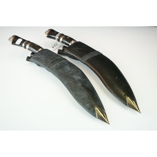 324 - Two kukri knives complete with tools and scabbards.