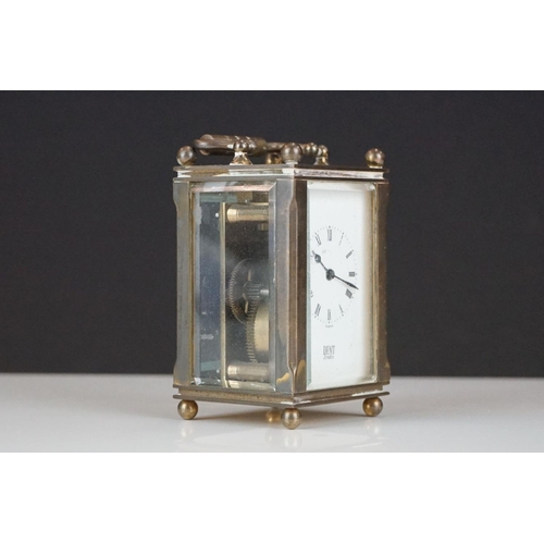 194 - A miniature brass cased carriage clock with beveled glass panels, marked Dent Of London.