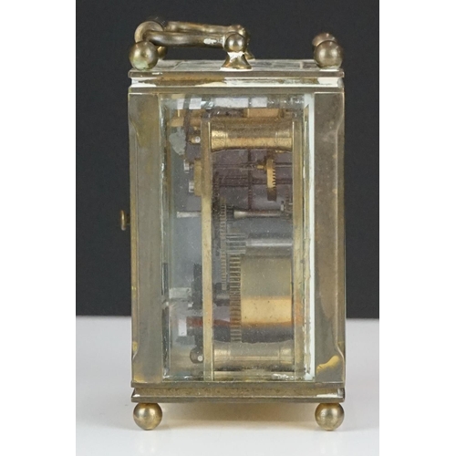 194 - A miniature brass cased carriage clock with beveled glass panels, marked Dent Of London.