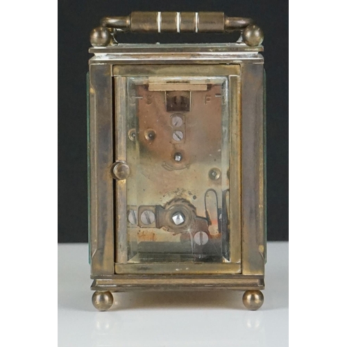 194 - A miniature brass cased carriage clock with beveled glass panels, marked Dent Of London.