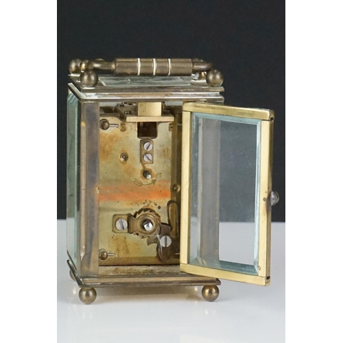 194 - A miniature brass cased carriage clock with beveled glass panels, marked Dent Of London.