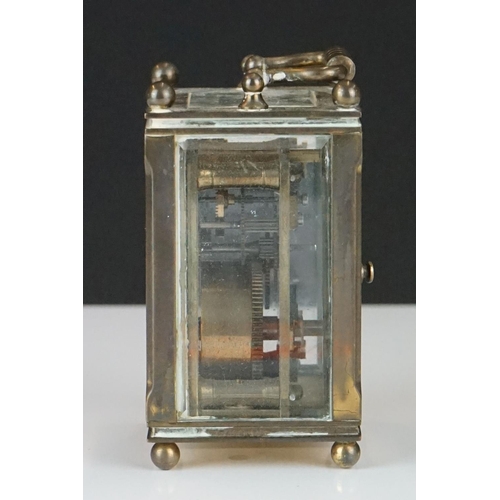 194 - A miniature brass cased carriage clock with beveled glass panels, marked Dent Of London.