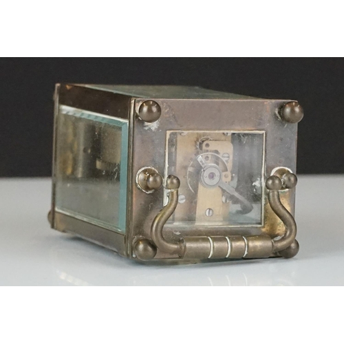 194 - A miniature brass cased carriage clock with beveled glass panels, marked Dent Of London.