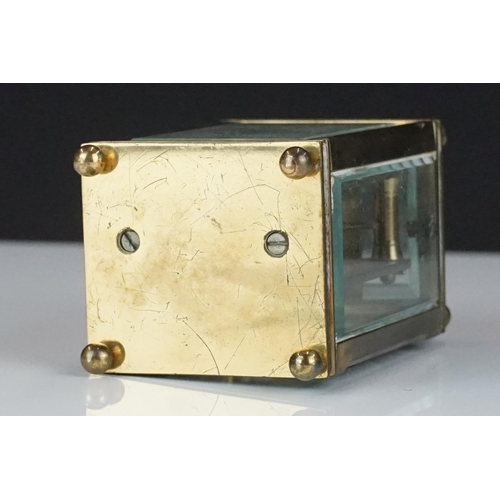 194 - A miniature brass cased carriage clock with beveled glass panels, marked Dent Of London.