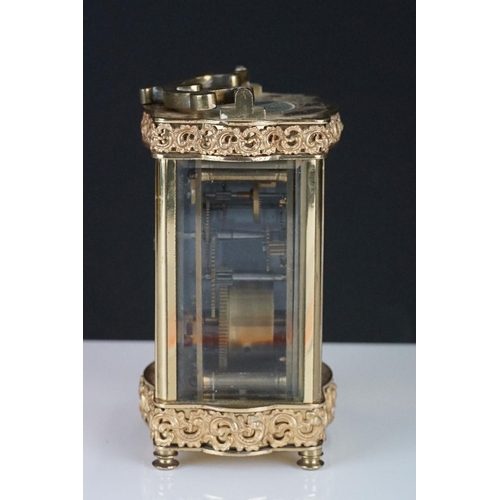 196 - An early 20th century brass cased carriage clock with bevelled glass panels and decorative dial, com... 