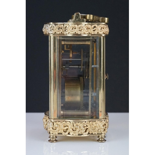 196 - An early 20th century brass cased carriage clock with bevelled glass panels and decorative dial, com... 