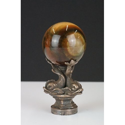 198 - A decorative seal with polished agate sphere sat upon three Chinese dolphins.