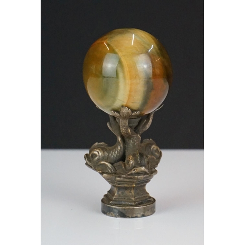 198 - A decorative seal with polished agate sphere sat upon three Chinese dolphins.