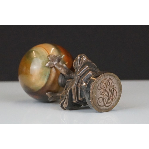 198 - A decorative seal with polished agate sphere sat upon three Chinese dolphins.