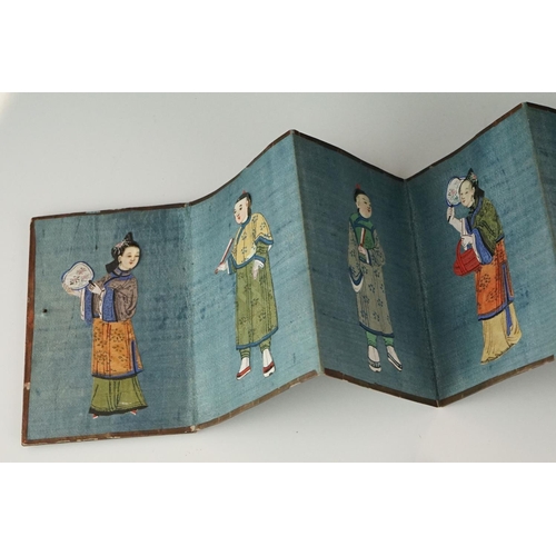 200 - A Chinese lacquer ware folding wallet of embroidered silk Chinese figures in traditional dress.