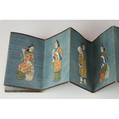 200 - A Chinese lacquer ware folding wallet of embroidered silk Chinese figures in traditional dress.