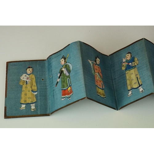 200 - A Chinese lacquer ware folding wallet of embroidered silk Chinese figures in traditional dress.