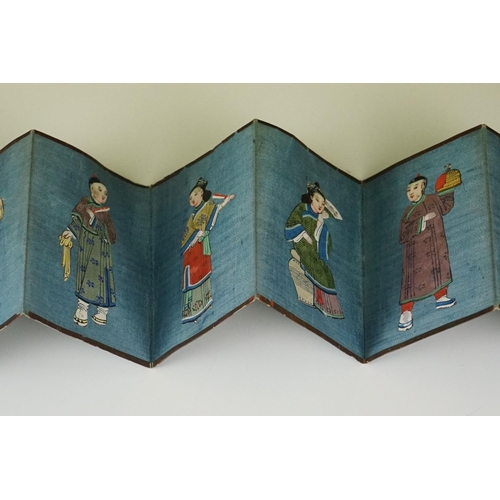 200 - A Chinese lacquer ware folding wallet of embroidered silk Chinese figures in traditional dress.