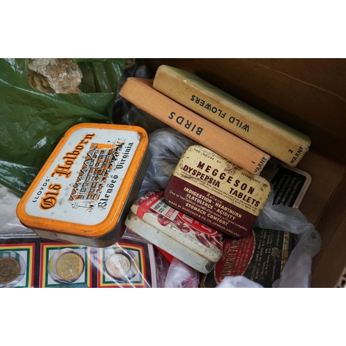 325 - A box of mixed collectables to include coins, tokens, advertising tins, crystals...etc..