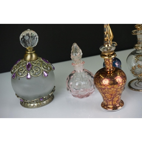 335 - A collection of Egyptian style hand blown glass scent bottles.