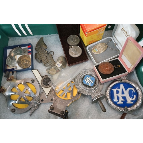 339 - A box of mixed collectables to include car badges, belt buckles, medals, fishing reel and Meccano.