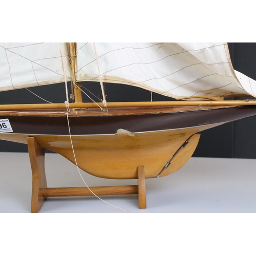 396 - Wooden Pond Yacht on stand, 64cm long