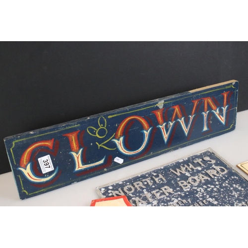 397 - Four Wooden Painted Fairground Signs together with a Wooden Painted ' Clown ' Sign 59cm long and an ... 