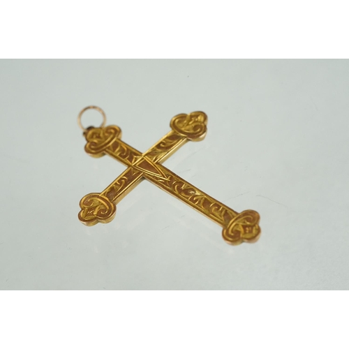 212 - A hallmarked 9ct gold cross pendant with engraved decoration.