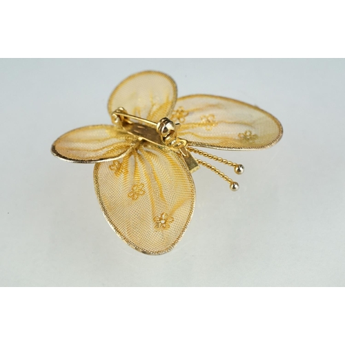 216 - A white metal muff / guard chain together with a yellow metal butterfly brooch.