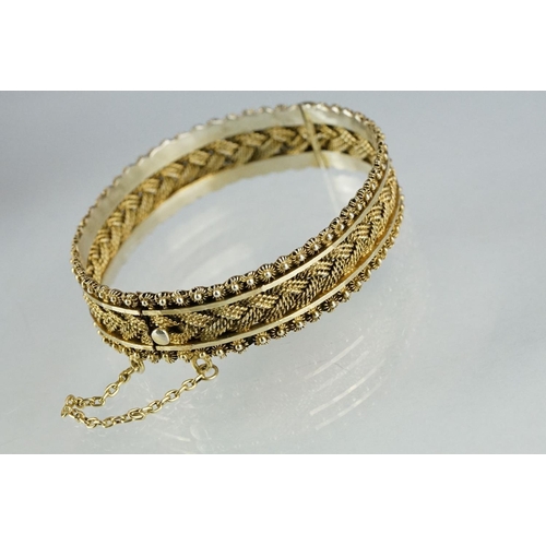 224 - A silver charm bracelet together with a silver gilt bangle.