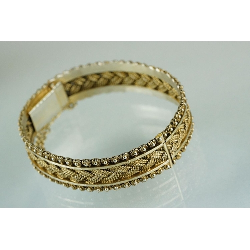 224 - A silver charm bracelet together with a silver gilt bangle.