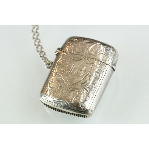 228A - A fully hallmarked sterling silver vesta case together with a sterling silver baby rattle in the for... 