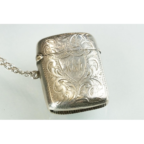 228A - A fully hallmarked sterling silver vesta case together with a sterling silver baby rattle in the for... 