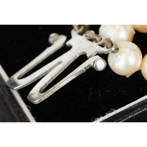 234 - A ladies pearl necklace with sterling silver Art Deco clasp together with a hallmarked gold ring.