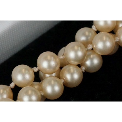 234 - A ladies pearl necklace with sterling silver Art Deco clasp together with a hallmarked gold ring.