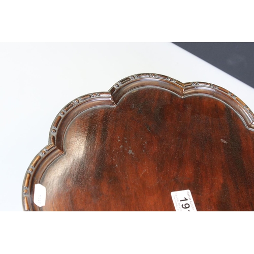 191 - 1930s mahogany lazy Susan of lobed form with beaded edge on turned support, diameter approx 37.5cm