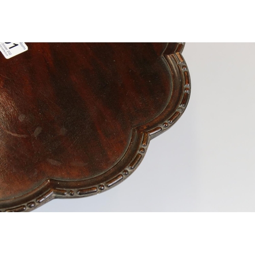 191 - 1930s mahogany lazy Susan of lobed form with beaded edge on turned support, diameter approx 37.5cm