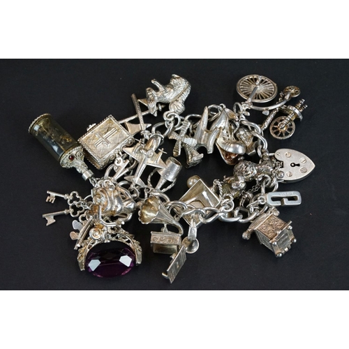 238 - A hallmarked sterling silver charm bracelet complete with a good quantity of charms together with a ... 