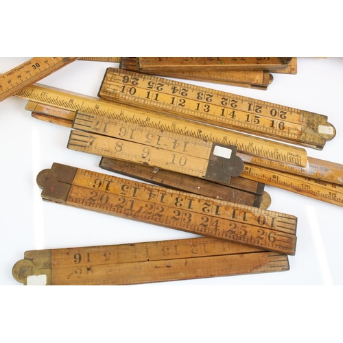 390 - Approximately Twenty Five Early to Mid century Wooden Rulers, some folding including Rabone, Helix p... 