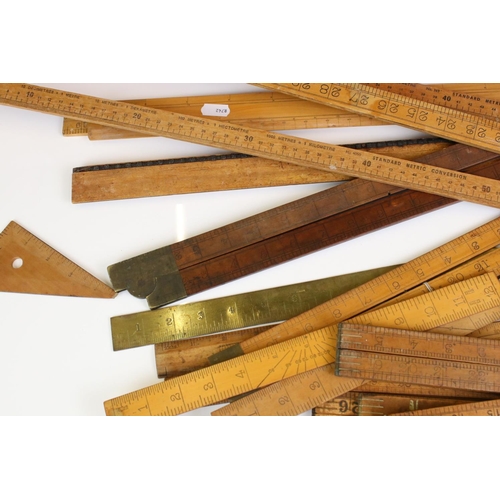 390 - Approximately Twenty Five Early to Mid century Wooden Rulers, some folding including Rabone, Helix p... 