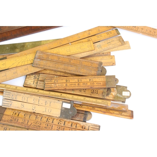 390 - Approximately Twenty Five Early to Mid century Wooden Rulers, some folding including Rabone, Helix p... 